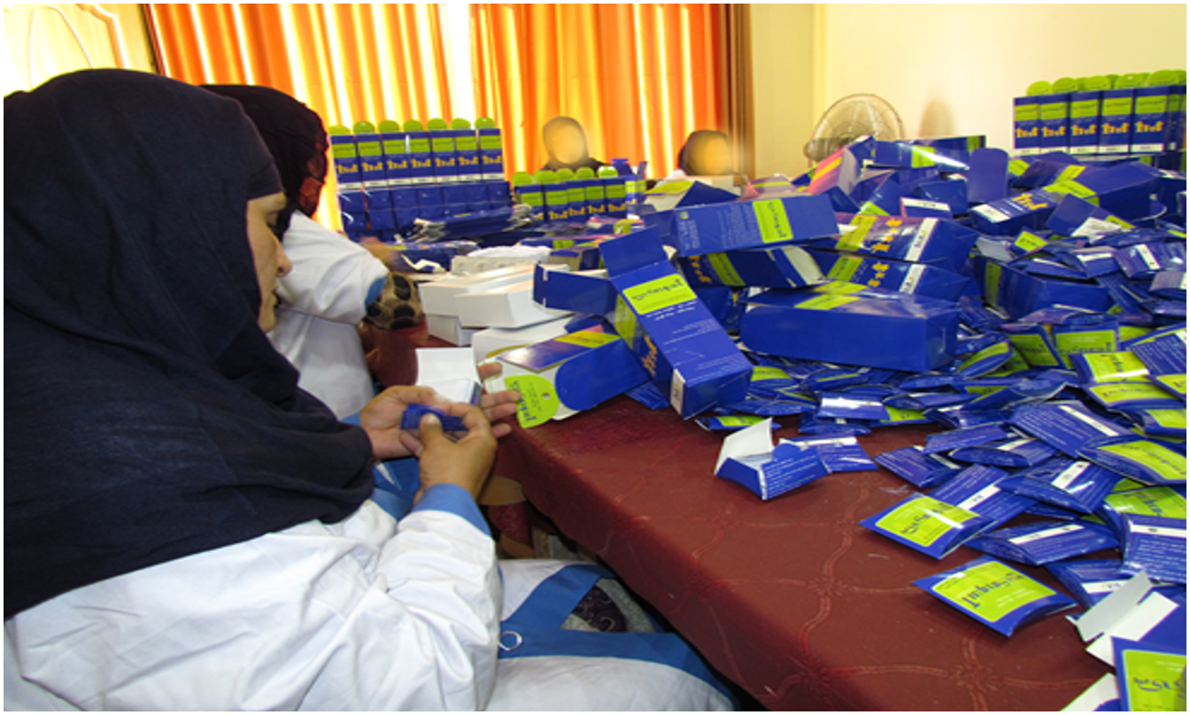 Women packing ASMO products